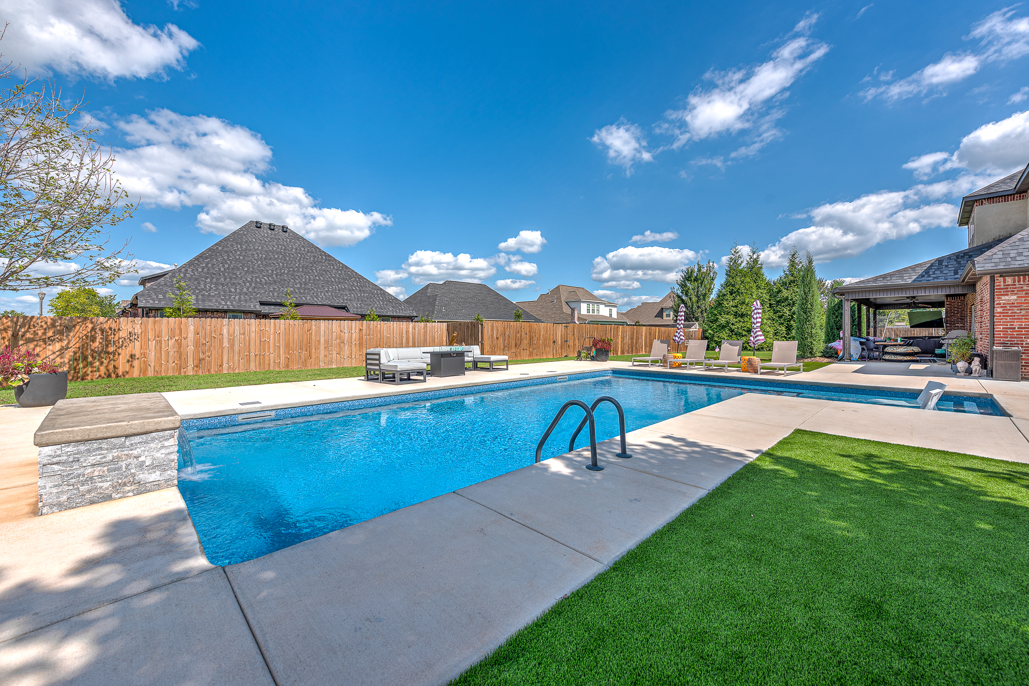 Resort-style backyard pool with custom water features in Fayetteville Arkansas