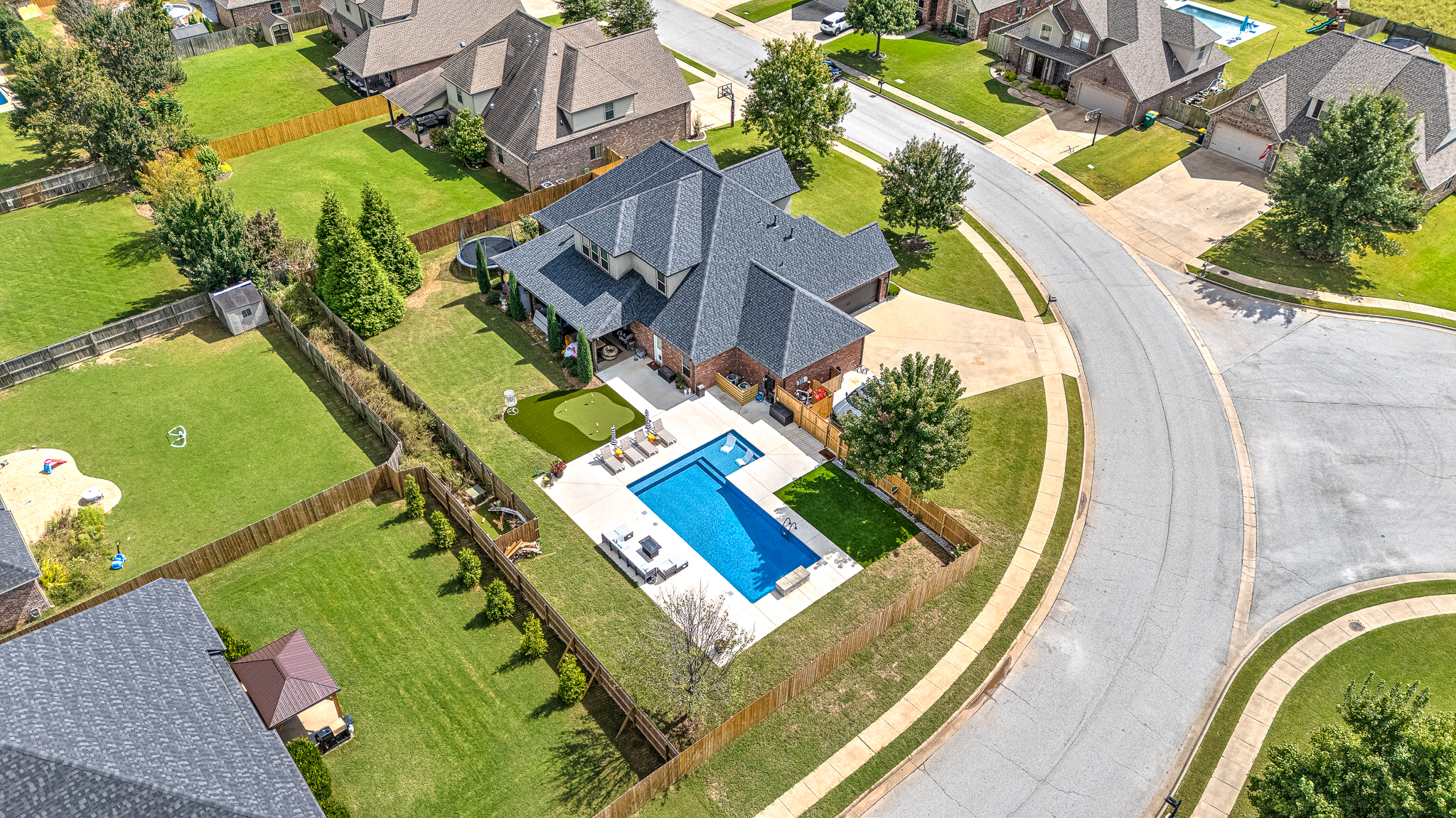 Inground pool with color-changing LED lighting at dusk - Northwest Arkansas