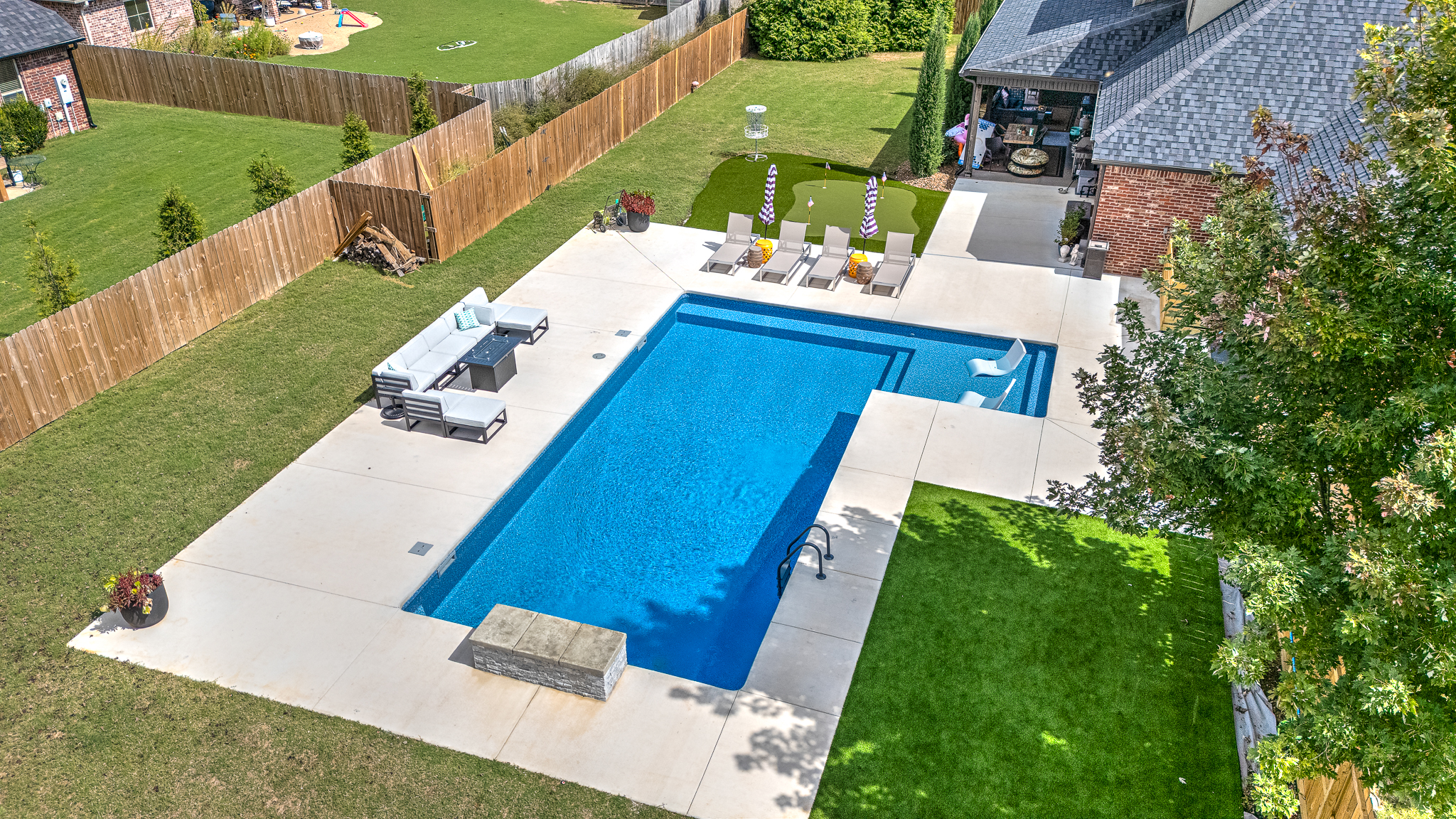 Luxury custom inground pool with waterfall feature - Saltscapes NWA