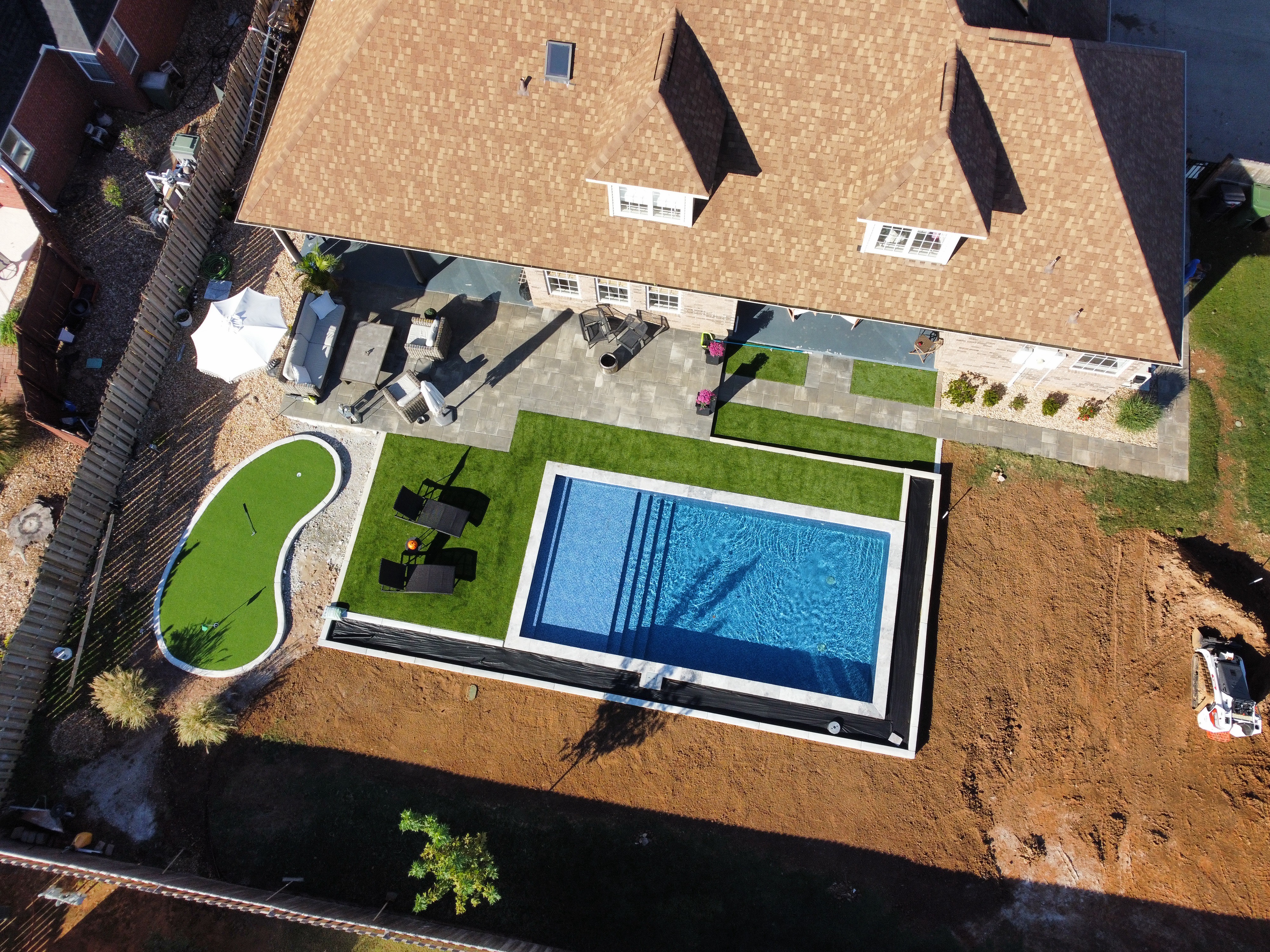 Custom backyard pool with water features and pool equipment - Saltscapes NWA