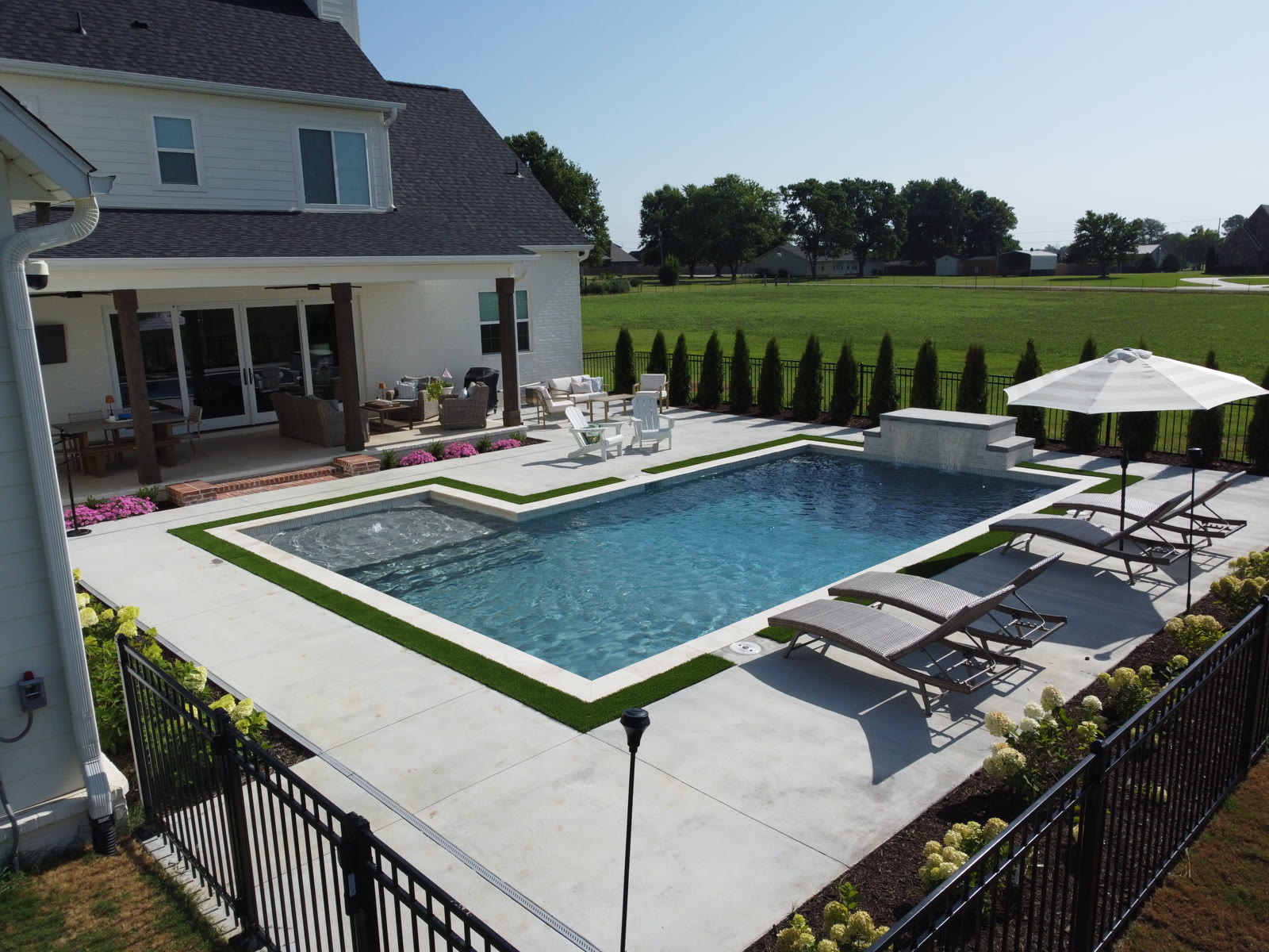 Custom inground shotcrete pool with tanning ledge and spa in Northwest Arkansas by Saltscapes NWA