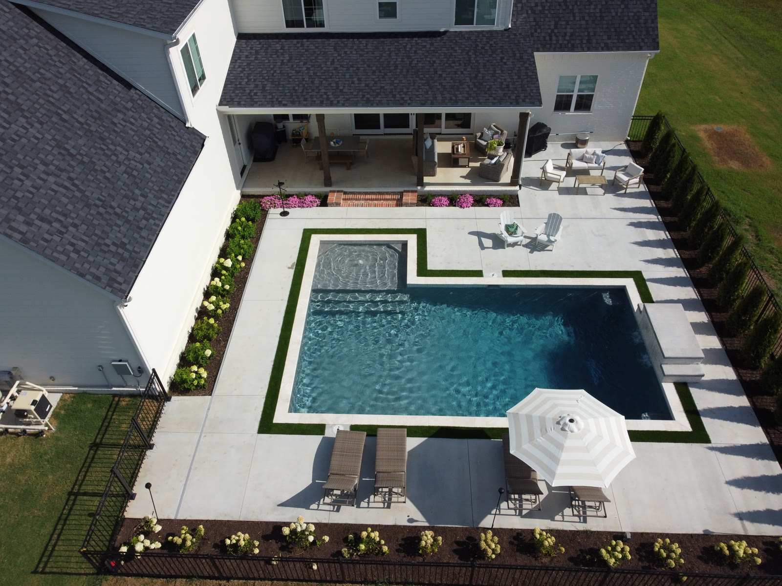 Aerial drone view of completed custom inground pool and backyard in Northwest Arkansas