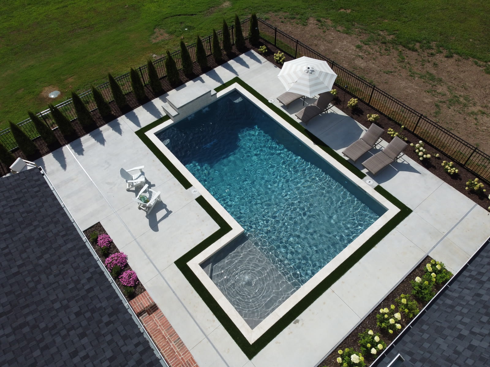 Aerial view of custom inground pool overlooking open NWA countryside - Saltscapes NWA